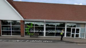 Shop front window film installation by Solar X